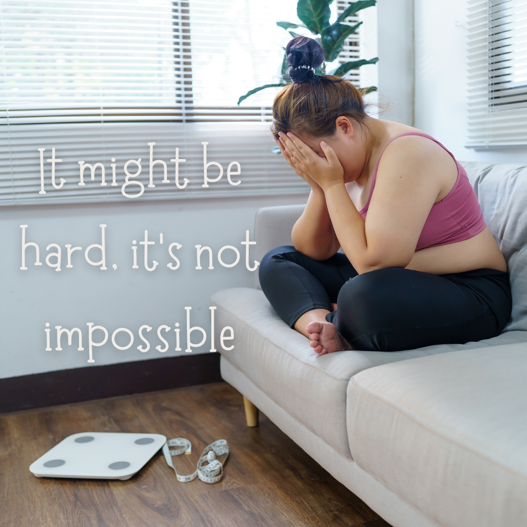 woman upset sitting next to a scale